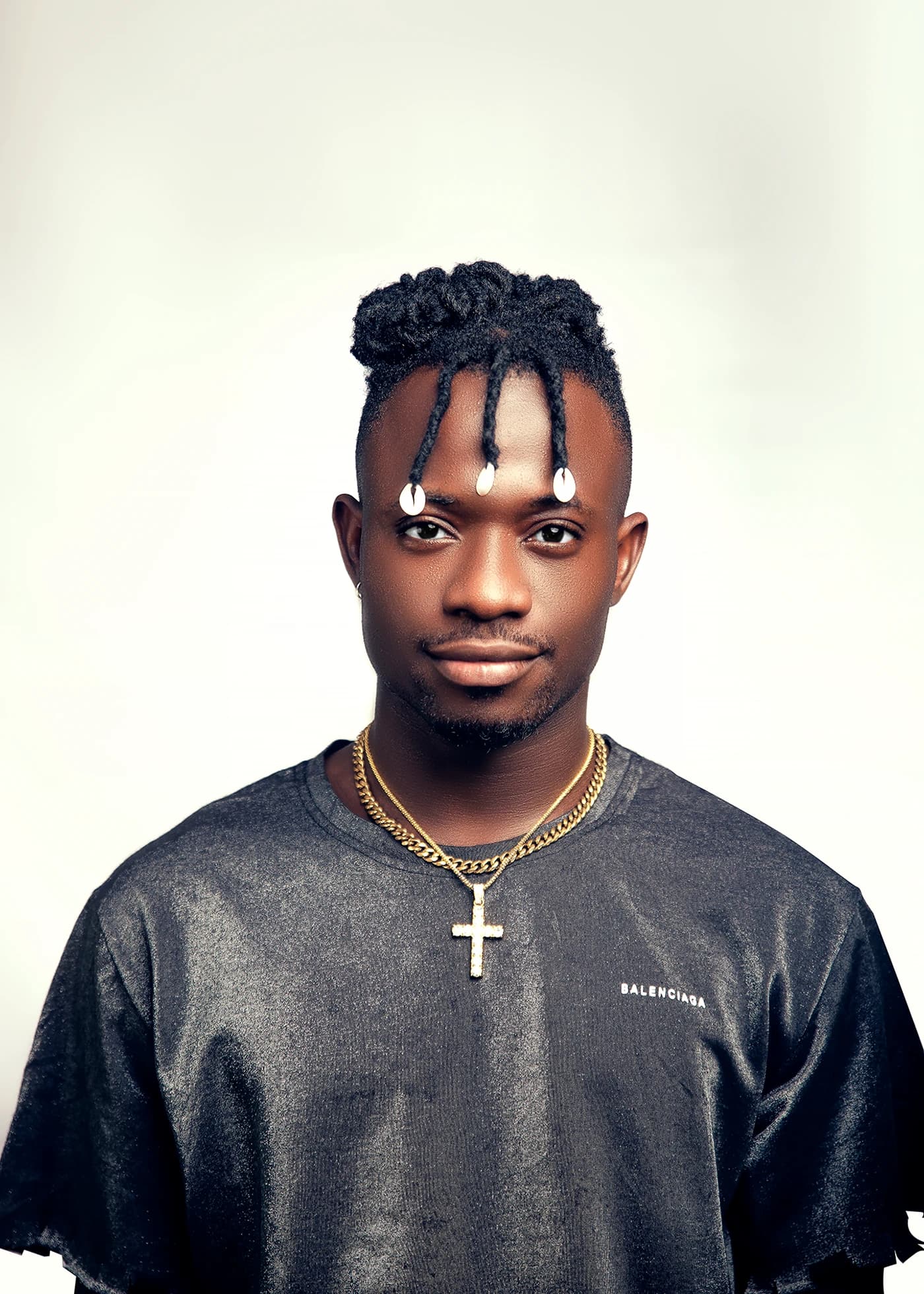 Clean studio portrait on white, gold chain and cross, looking straight to camera