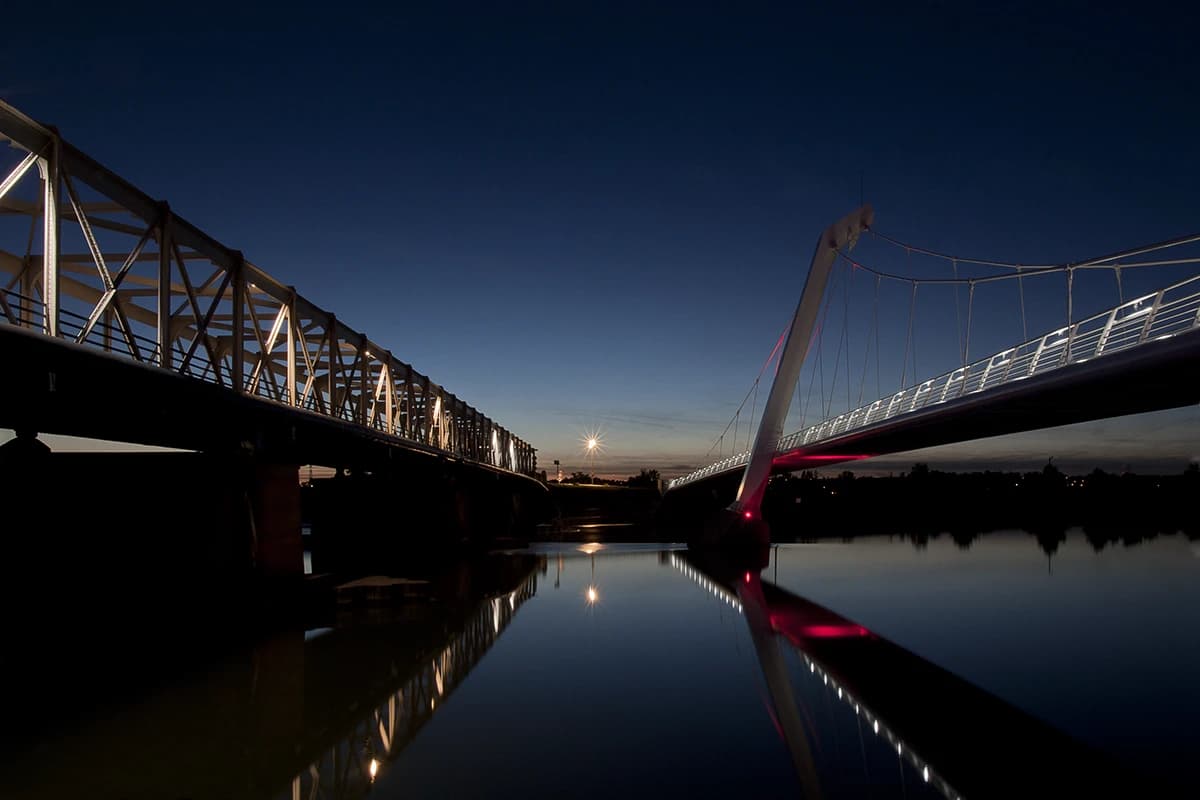 Both bridges converging towards the last of the sunset, the moon low over the river between them